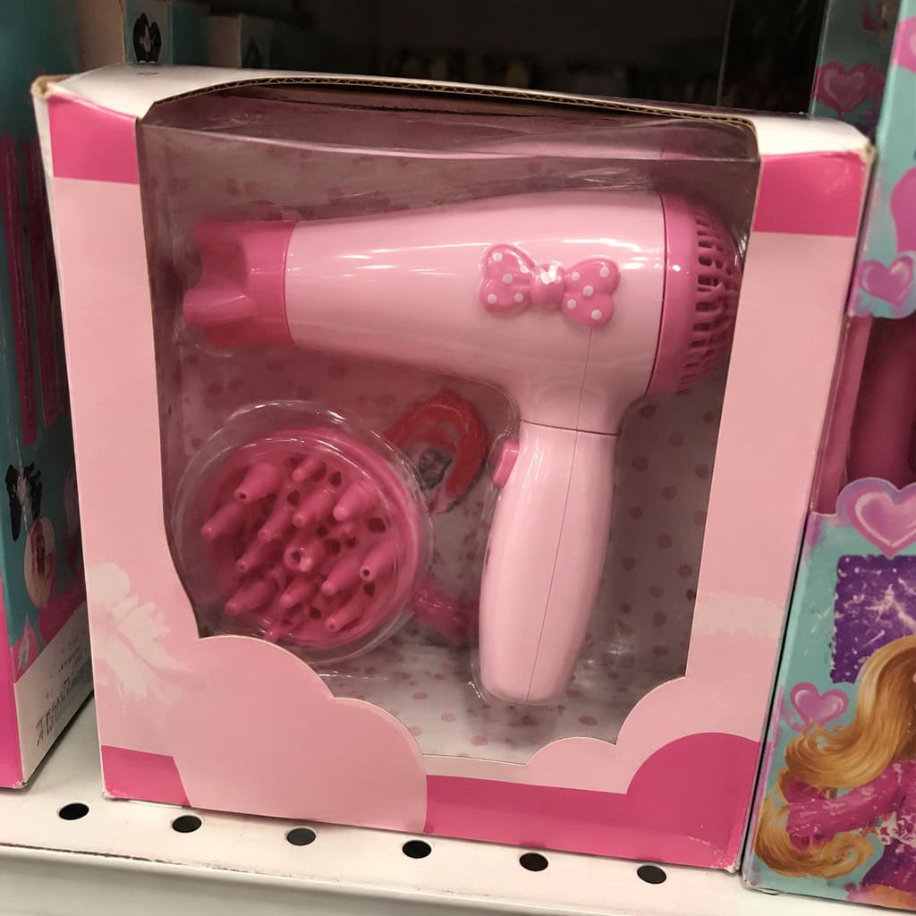 Pink kids hair dryer in retail packaging