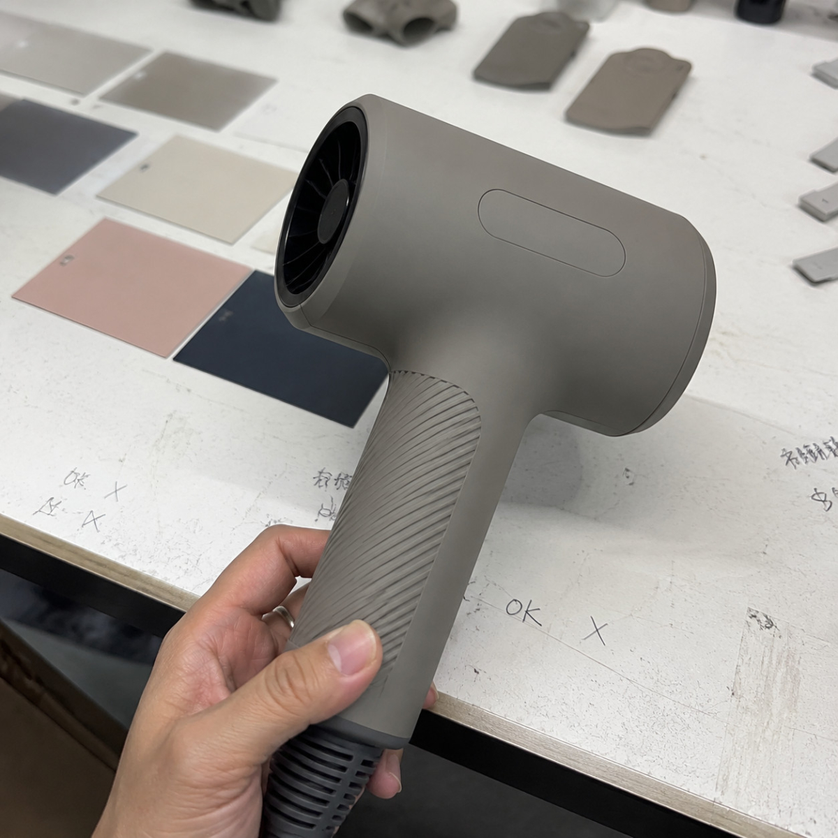 Hair dryer housing color sample beside color cards