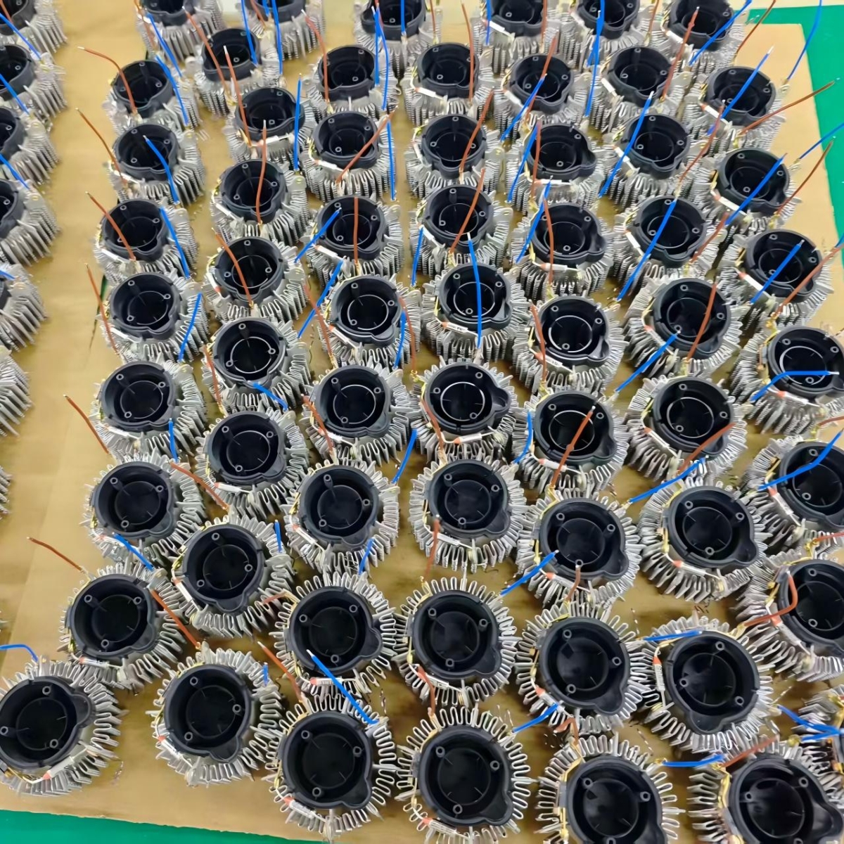 Hair dryer components arranged in a factory assembly area